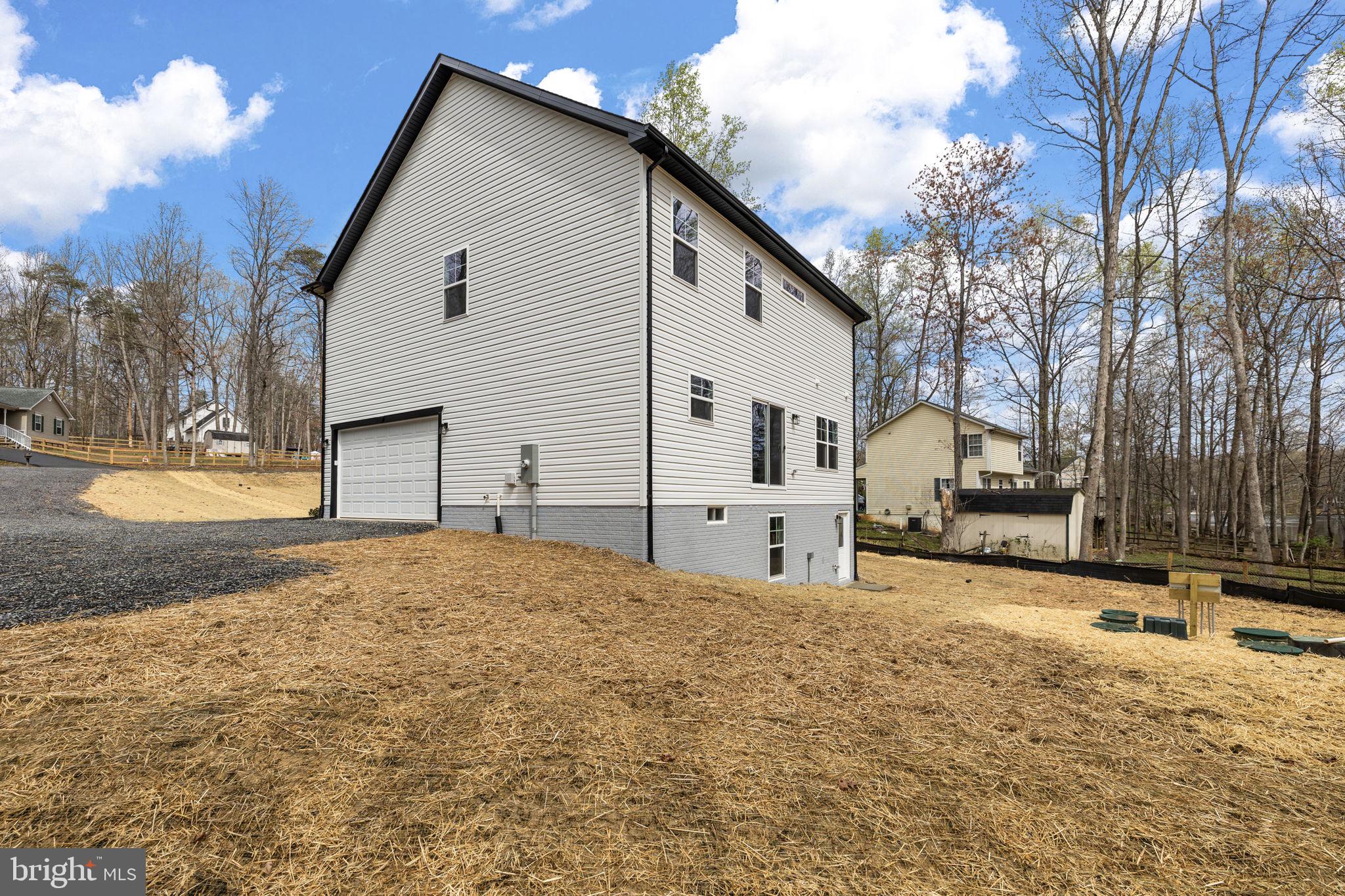 12413 Toll House Road Spotsylvania, VA 22551 - Photo 48 of 68 a view of a house with a yard covered in snow