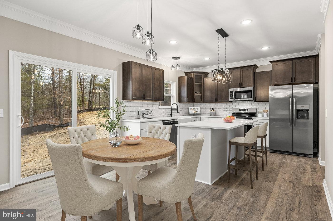 12413 Toll House Road Spotsylvania, VA 22551 - Photo 5 of 68 a kitchen with kitchen island a dining table chairs stainless steel appliances and cabinets