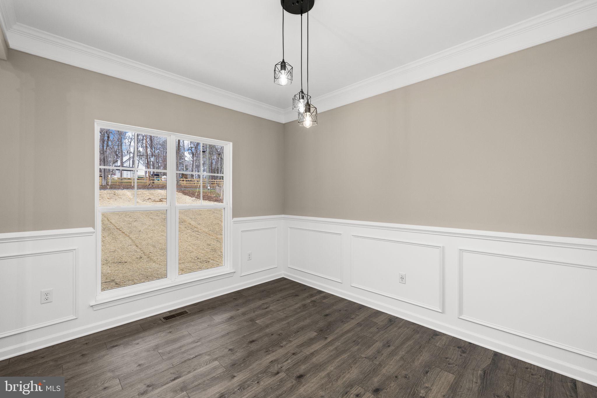 12413 Toll House Road Spotsylvania, VA 22551 - Photo 8 of 68 a view of an empty room with wooden floor and a window
