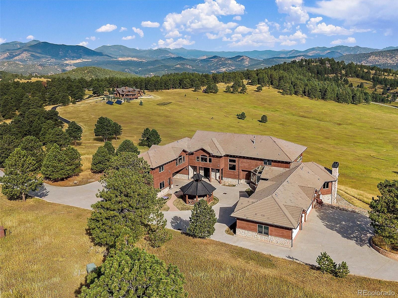 4213 Nambe Road Indian Hills, CO 80454 - Photo 1 of 49 an aerial view of a house with a ocean view