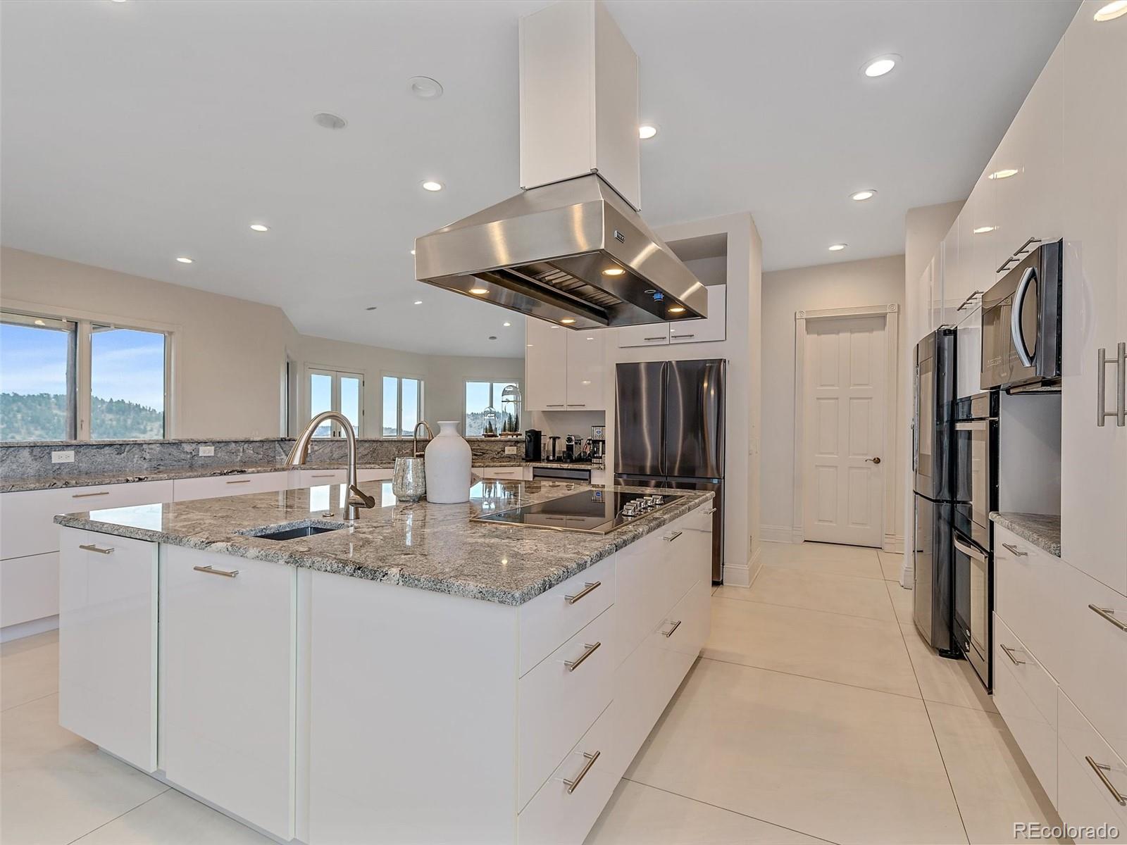 4213 Nambe Road Indian Hills, CO 80454 - Photo 15 of 49 a kitchen with stainless steel appliances granite countertop a sink a stove and a refrigerator