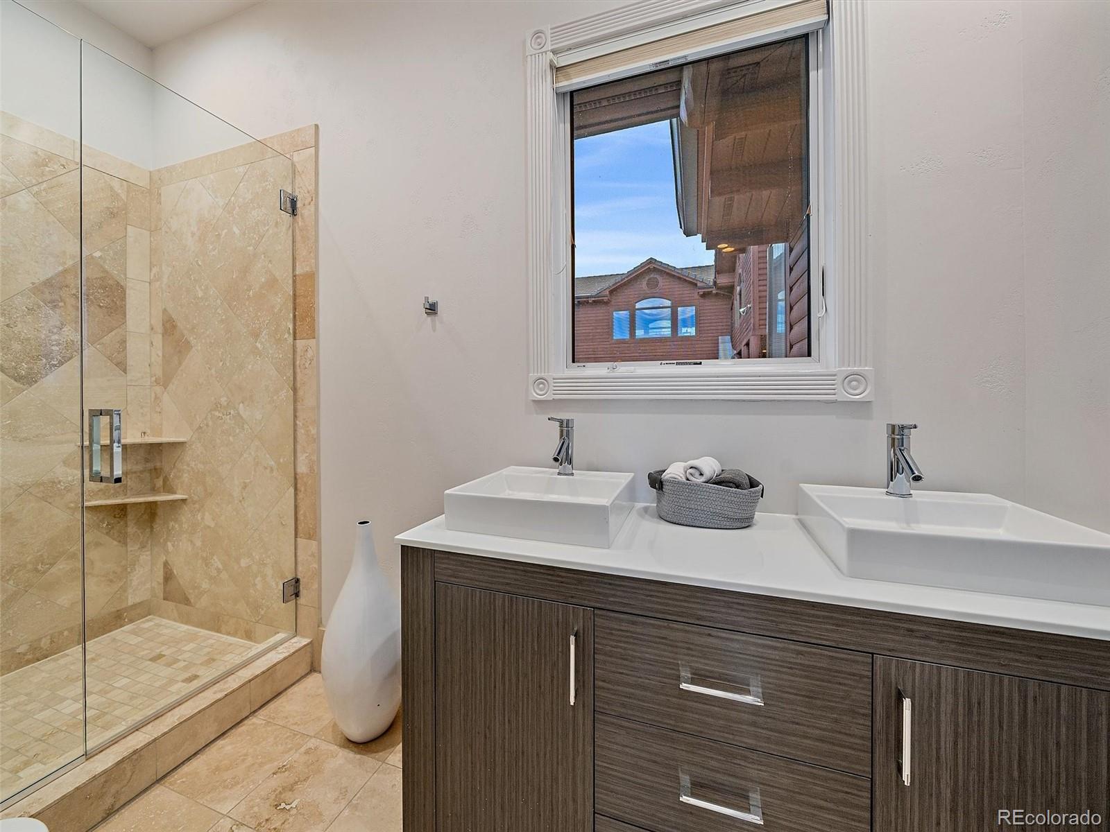 4213 Nambe Road Indian Hills, CO 80454 - Photo 18 of 49 a bathroom with a sink and a mirror