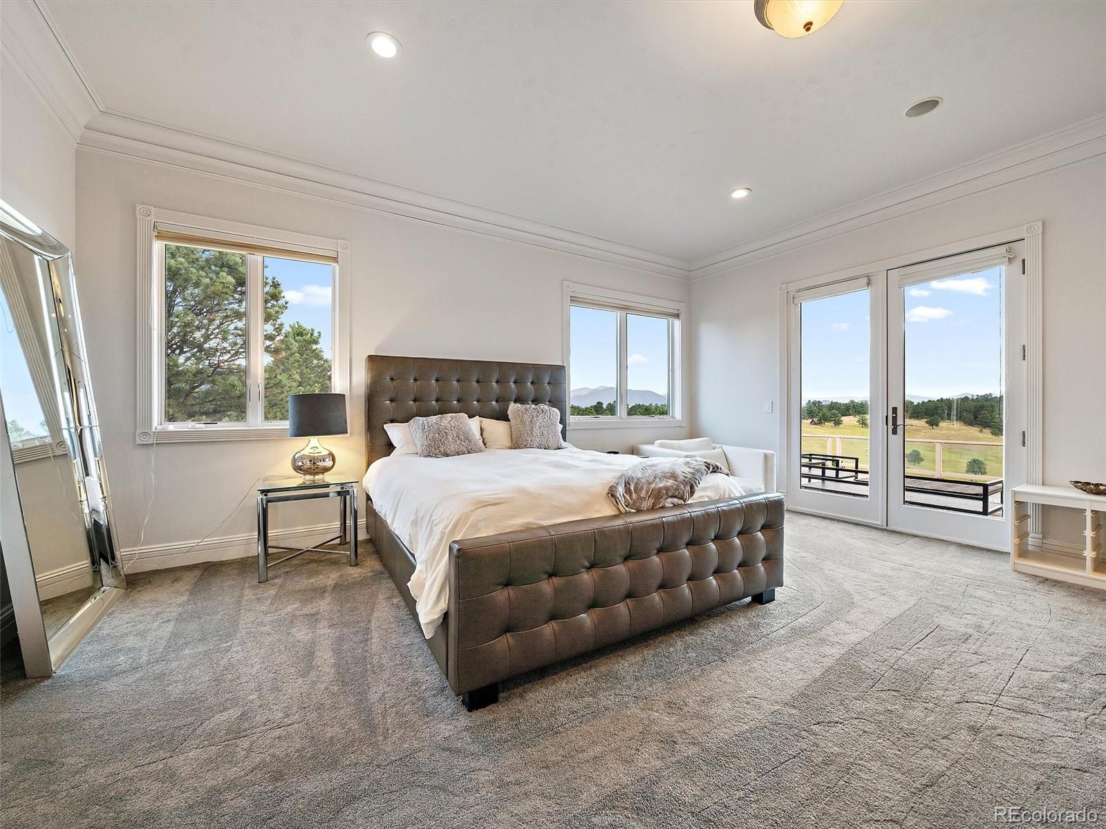 4213 Nambe Road Indian Hills, CO 80454 - Photo 20 of 49 a bed sitting in a spacious bedroom next to a window
