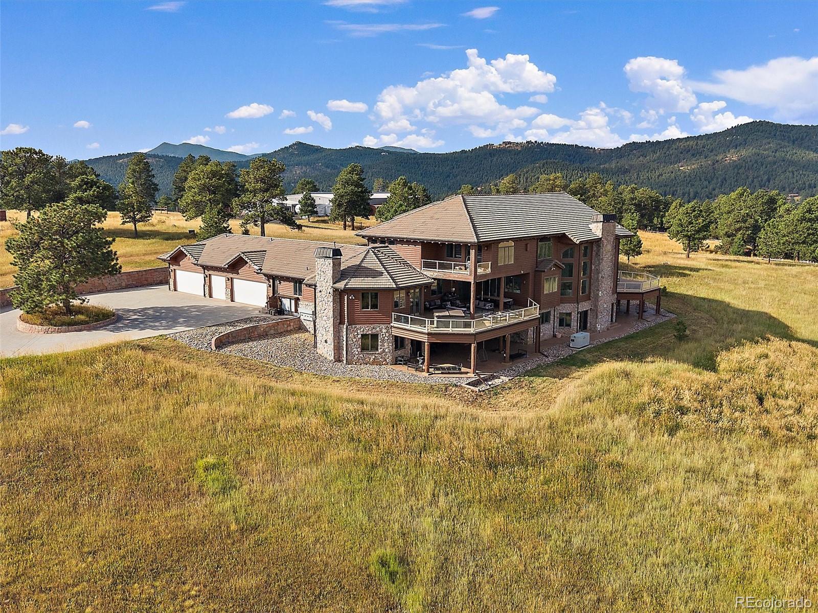 4213 Nambe Road Indian Hills, CO 80454 - Photo 2 of 49 a view of a swimming pool with mountains in the background