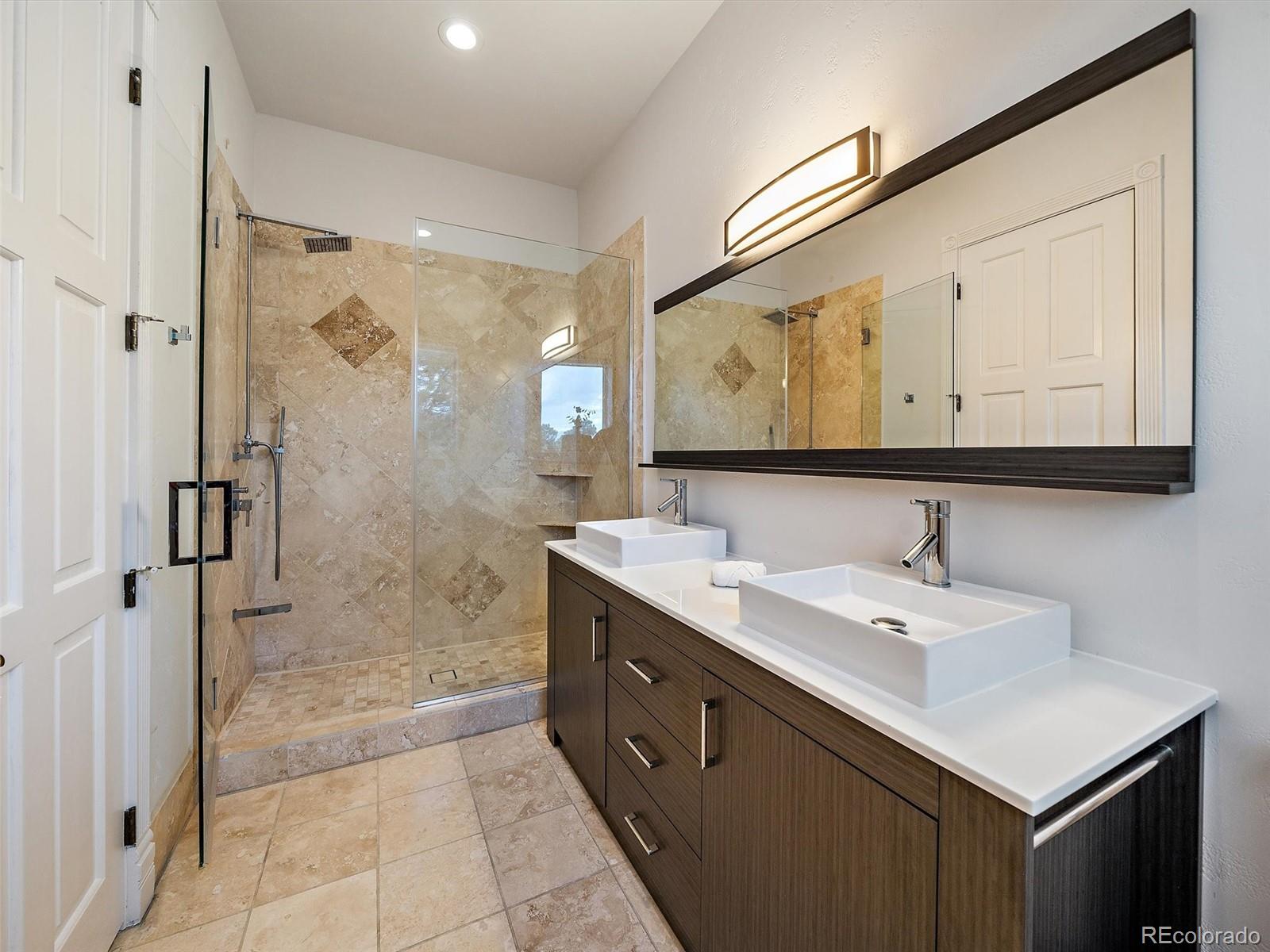 4213 Nambe Road Indian Hills, CO 80454 - Photo 21 of 49 a bathroom with a sink mirror and a shower