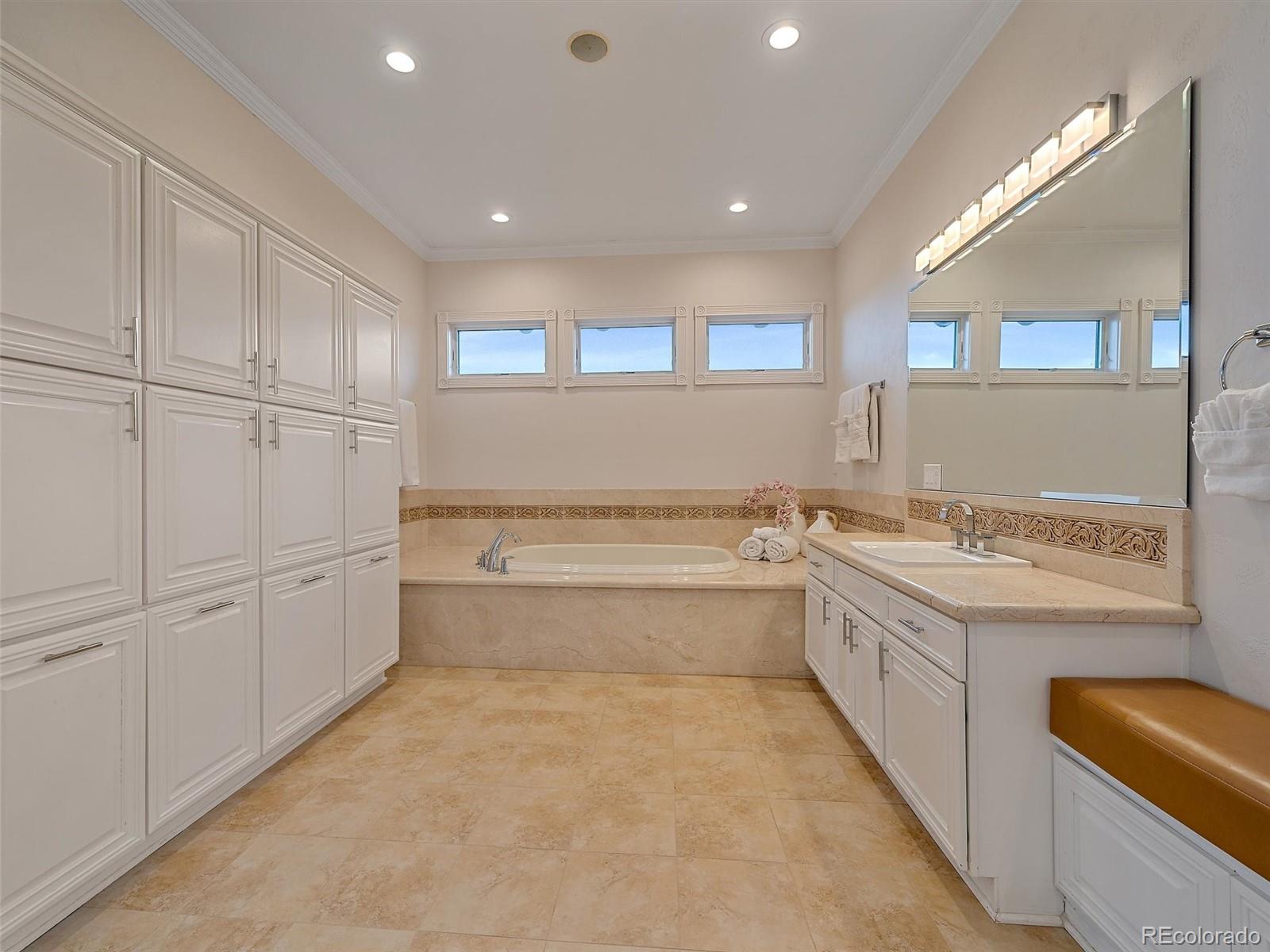 4213 Nambe Road Indian Hills, CO 80454 - Photo 26 of 49 a bathroom with a granite countertop sink a toilet and bathtub