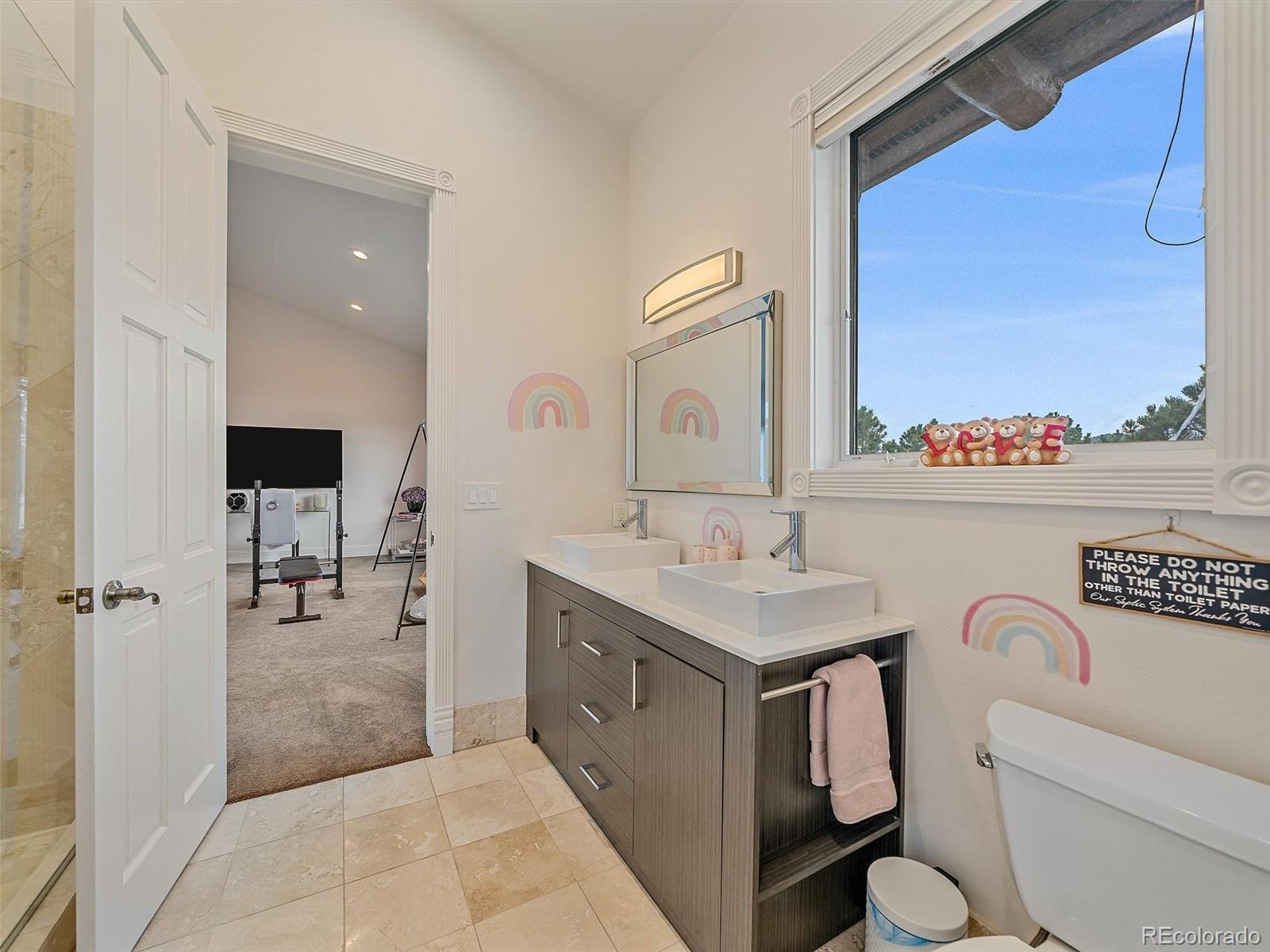 4213 Nambe Road Indian Hills, CO 80454 - Photo 31 of 49 a bathroom with a toilet sink and mirror