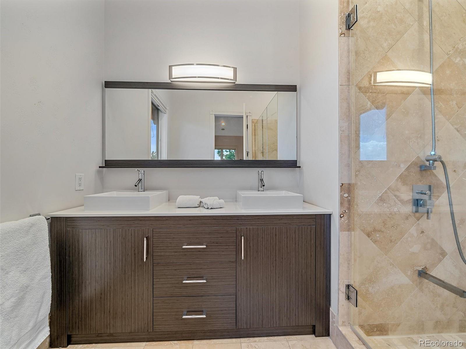 4213 Nambe Road Indian Hills, CO 80454 - Photo 34 of 49 a bathroom with a sink and a mirror