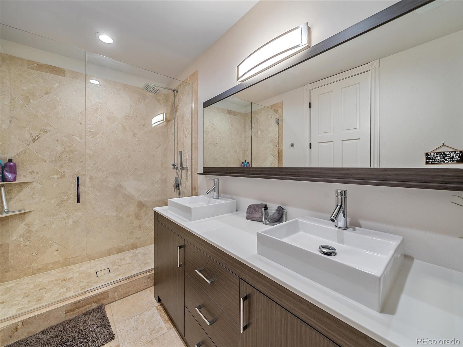 4213 Nambe Road Indian Hills, CO 80454 - Photo 41 of 49 a bathroom with a sink and a mirror