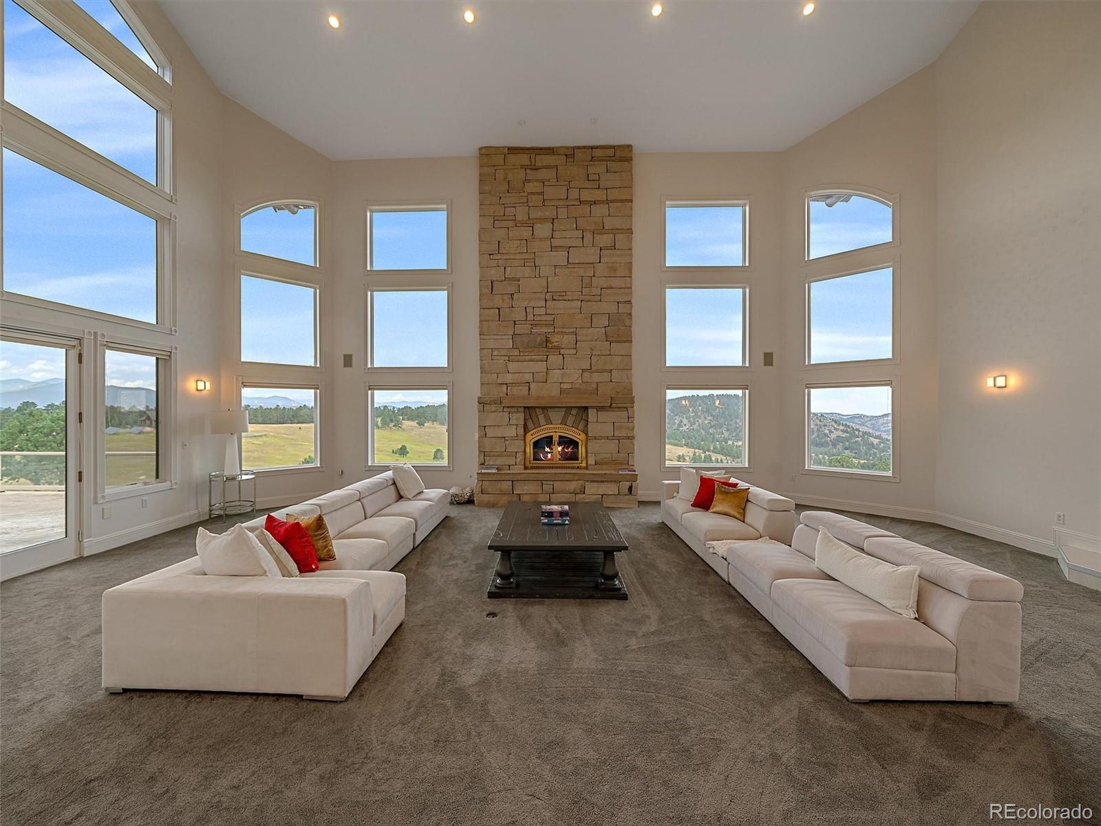 4213 Nambe Road Indian Hills, CO 80454 - Photo 7 of 49 a living room with furniture and floor to ceiling windows