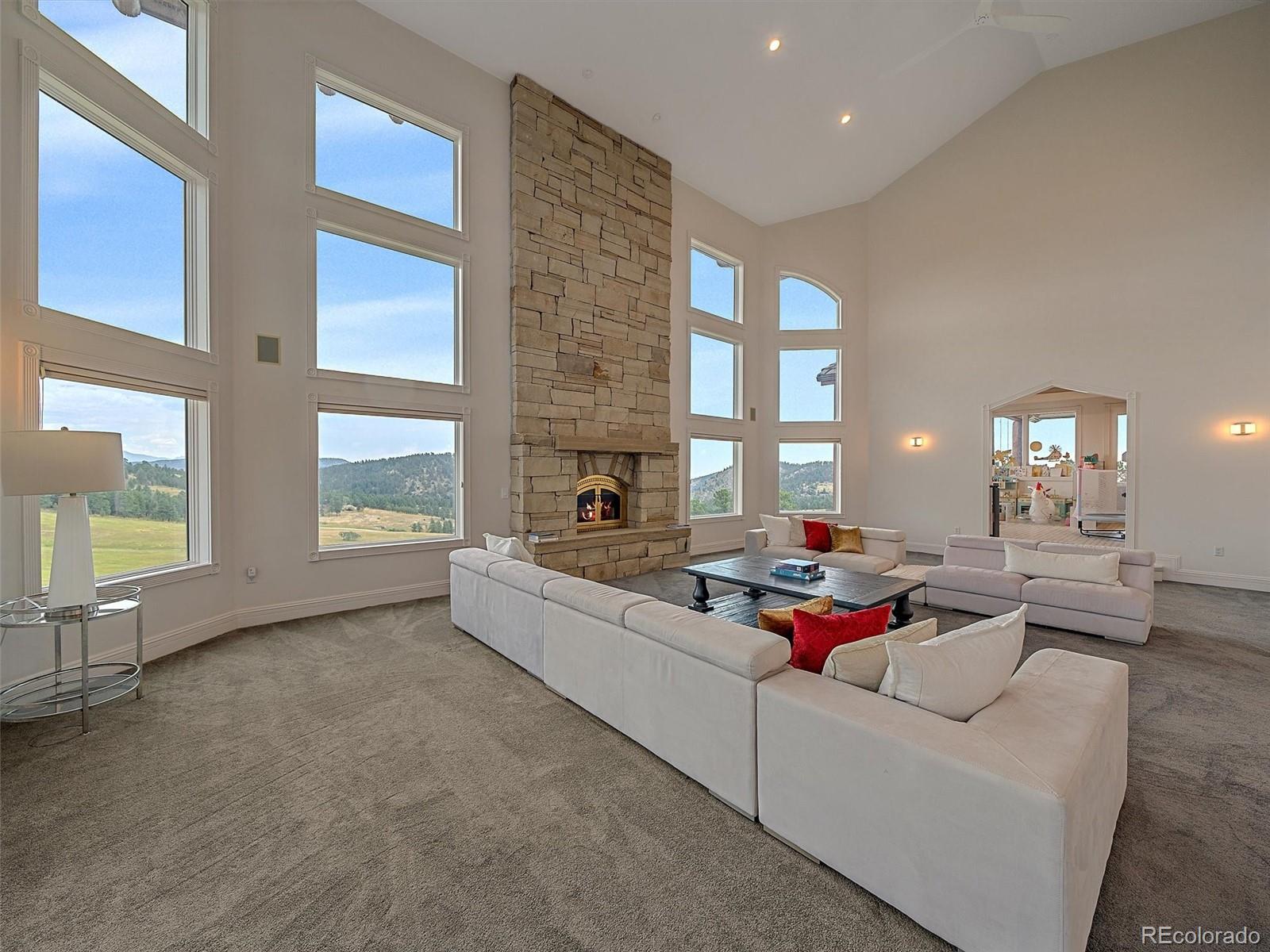 4213 Nambe Road Indian Hills, CO 80454 - Photo 8 of 49 a living room with furniture and a floor to ceiling window