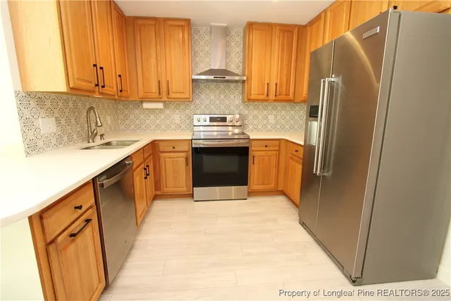 a kitchen with stainless steel appliances granite countertop a sink a stove and a microwave