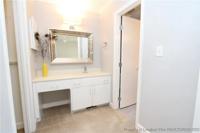an empty room with a ceiling fan and carpet