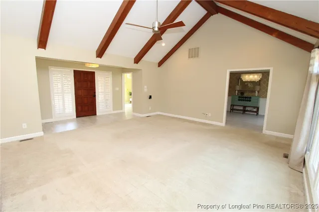 a view of an empty room with a fireplace