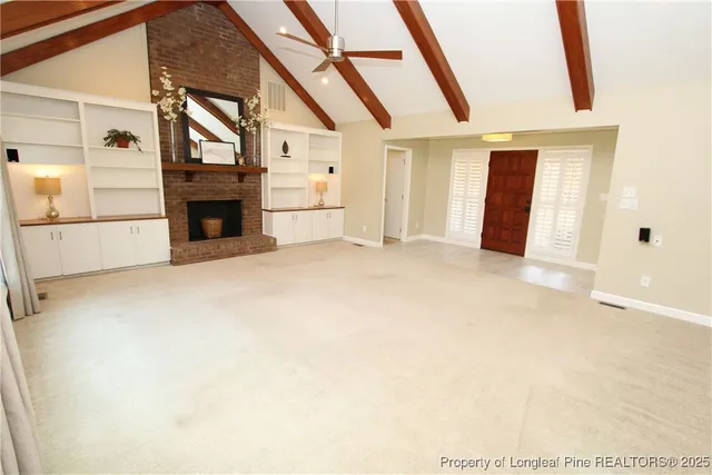 a living room with a fireplace in it and a large window