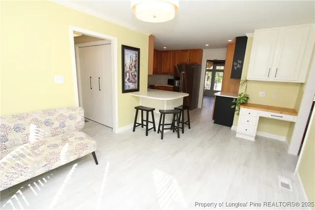 a view of kitchen with furniture and refrigerator
