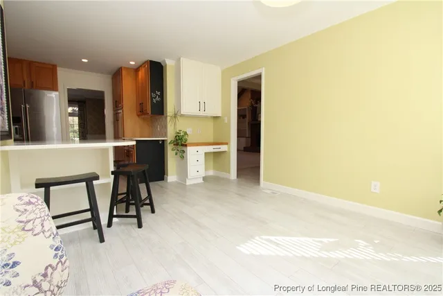 a view of a bedroom with a bed and a window