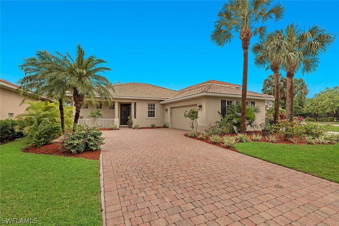 12941 Timber Ridge Drive Fort Myers, FL 33913 - Photo 1 of 30 a front view of a house with a garden