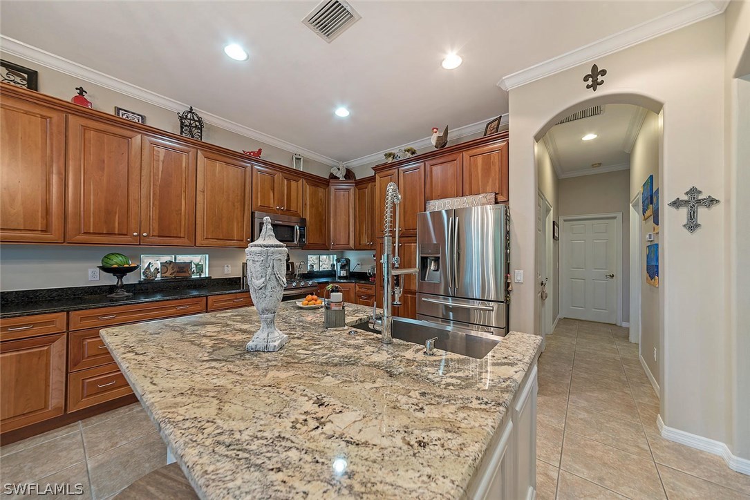 12941 Timber Ridge Drive Fort Myers, FL 33913 - Photo 8 of 30 a kitchen with stainless steel appliances granite countertop sink refrigerator and cabinets
