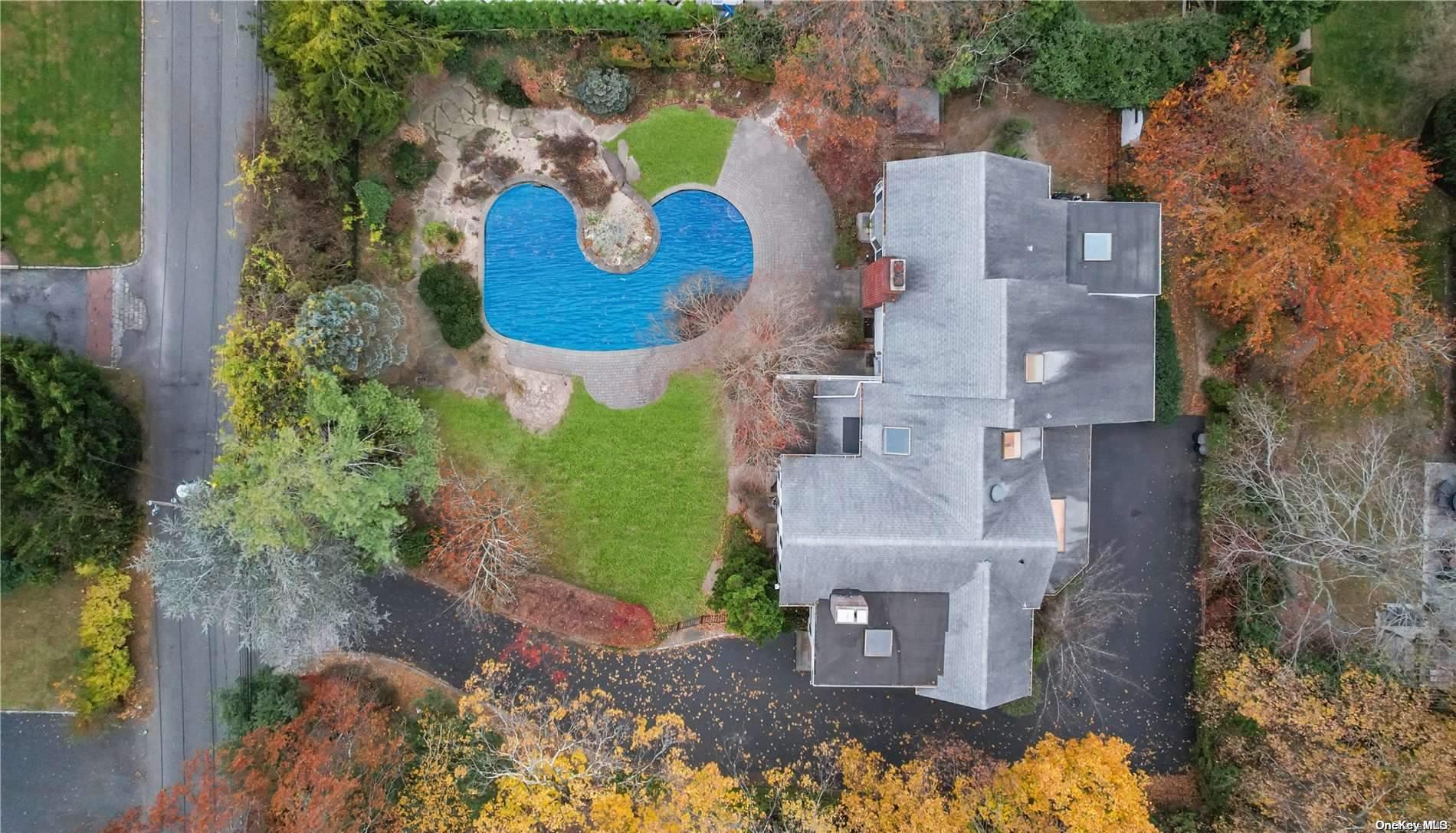 an aerial view of residential house with outdoor space and parking