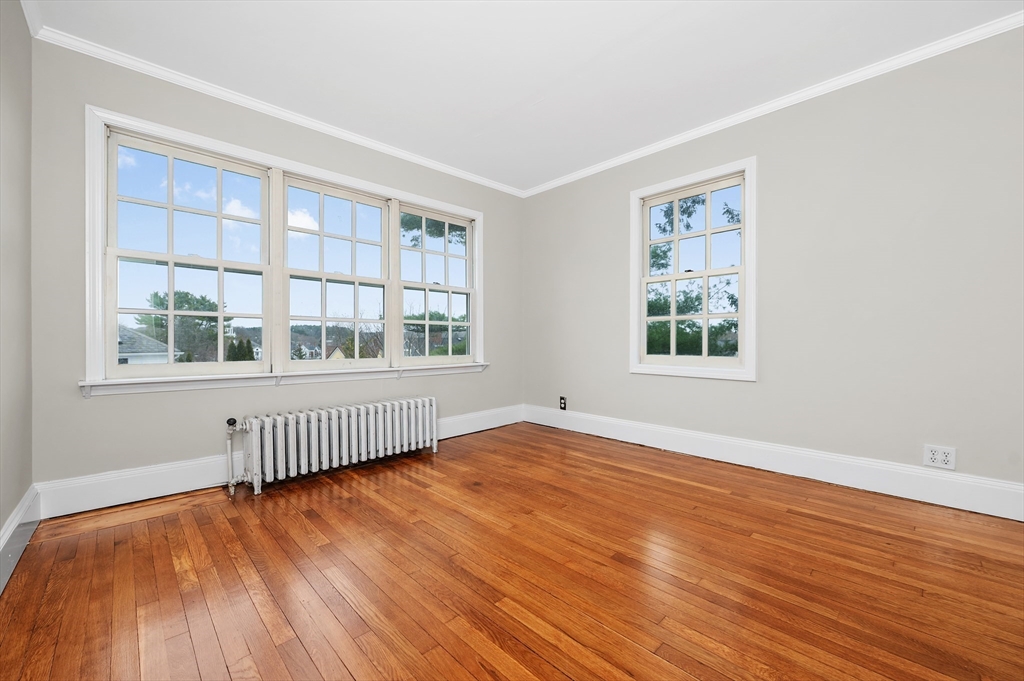 18 Bennett Street, Unit 2 Manchester, MA 01944 - Photo 19 of 21 a view of empty room with wooden floor and fan