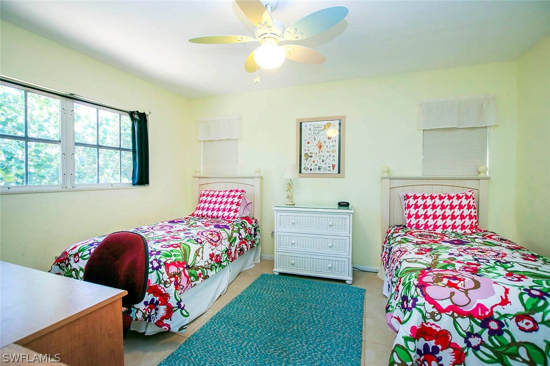 555 Rabbit Road Sanibel, FL 33957 - Photo 14 of 29 a bedroom with a bed and a dresser
