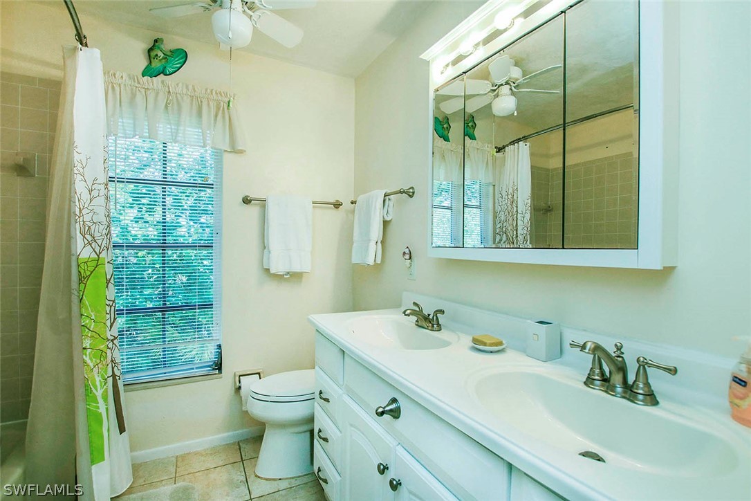 555 Rabbit Road Sanibel, FL 33957 - Photo 15 of 29 a bathroom with a double vanity sink toilet and shower