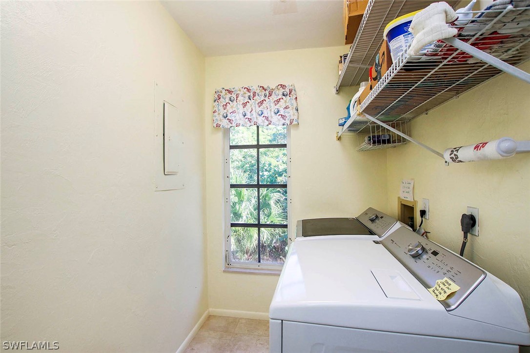 555 Rabbit Road Sanibel, FL 33957 - Photo 16 of 29 a living room with a bed and a window
