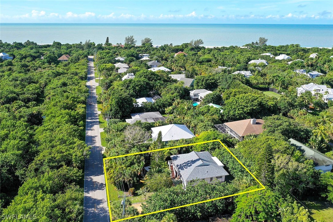 555 Rabbit Road Sanibel, FL 33957 - Photo 2 of 29 an aerial view of a houses with yard and outdoor seating