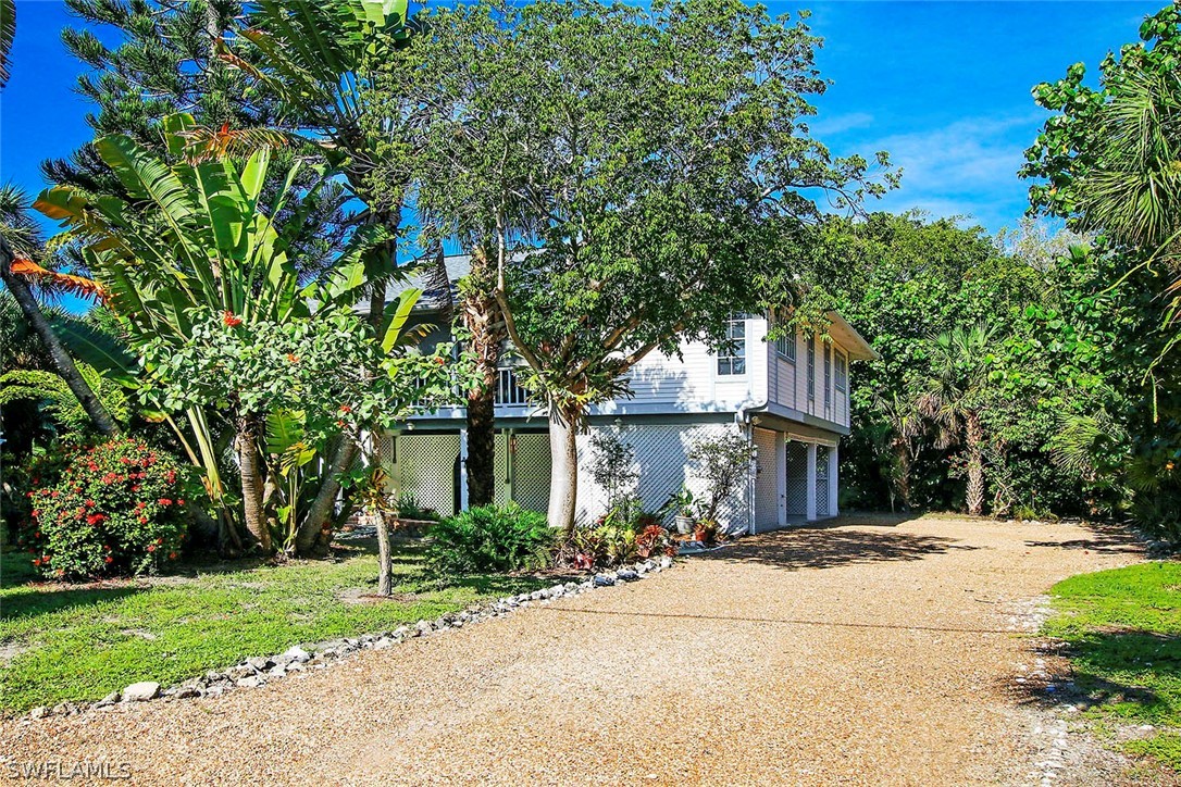 555 Rabbit Road Sanibel, FL 33957 - Photo 22 of 29 a front view of a house with a yard