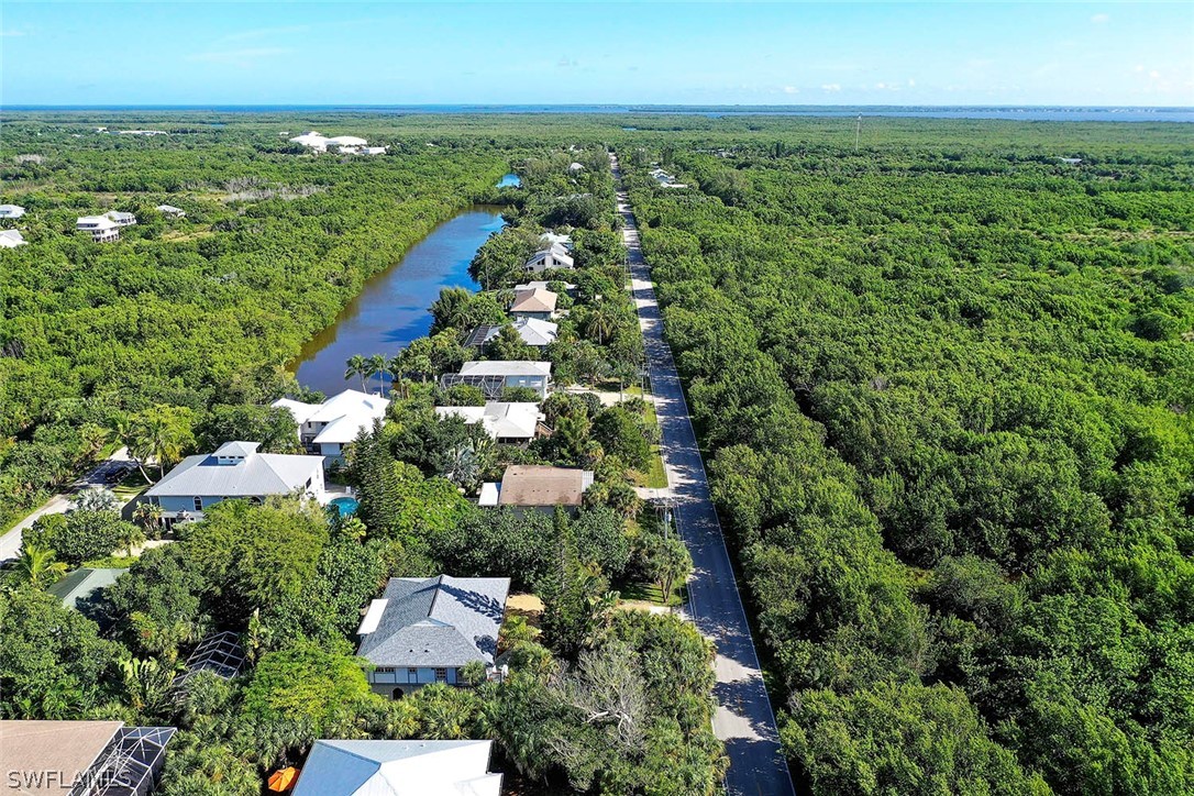 555 Rabbit Road Sanibel, FL 33957 - Photo 26 of 29 an aerial view of residential houses with outdoor space and trees