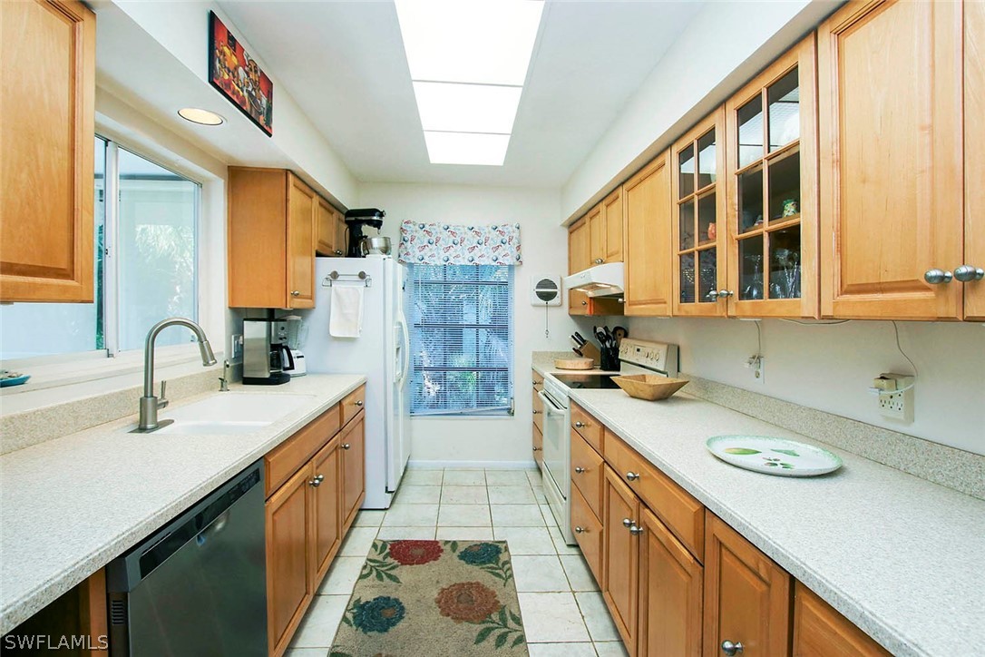 555 Rabbit Road Sanibel, FL 33957 - Photo 4 of 29 a kitchen with a sink stove and cabinets