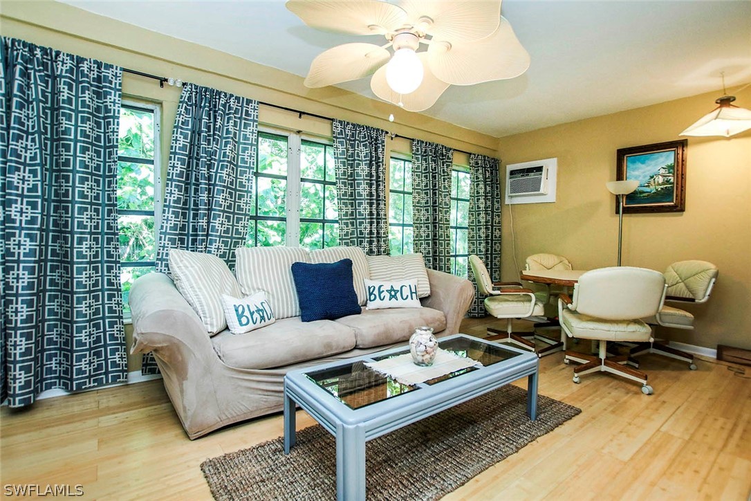 555 Rabbit Road Sanibel, FL 33957 - Photo 9 of 29 a living room with furniture a table and a large window