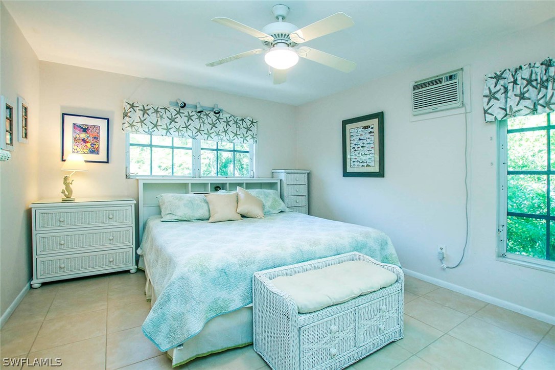 555 Rabbit Road Sanibel, FL 33957 - Photo 10 of 29 a bed room with a bed and a window