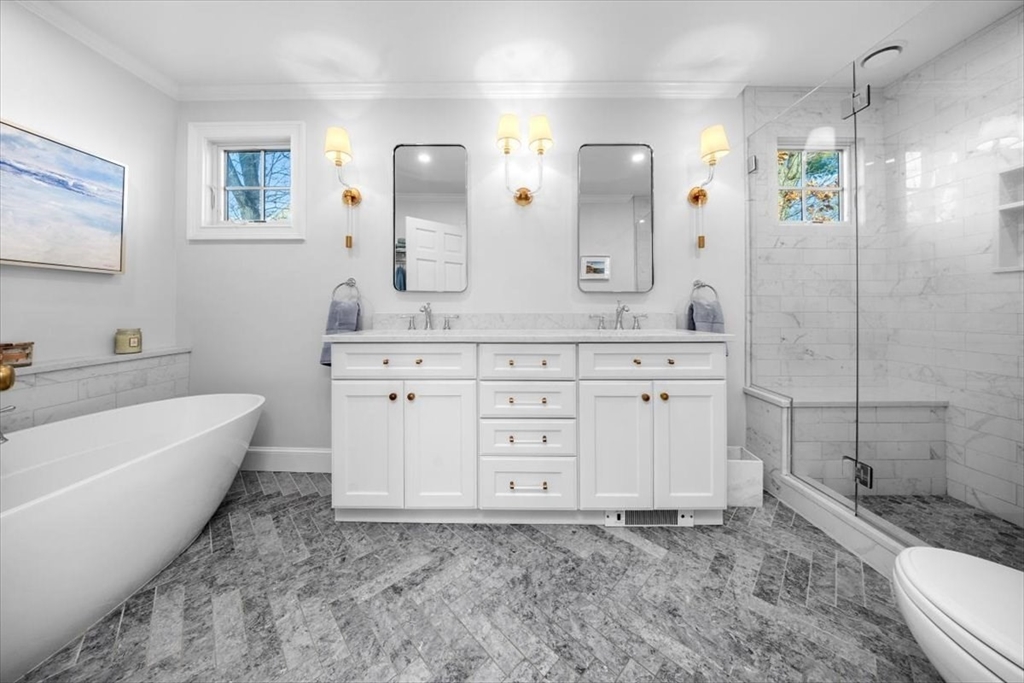 38 Smith Road Hingham, MA 02043 - Photo 17 of 42 a spacious bathroom with a granite countertop sink a toilet a mirror and shower