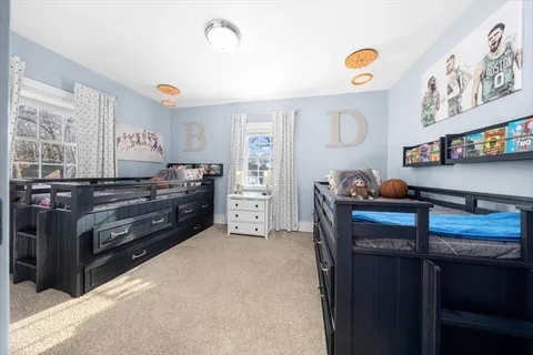 a bedroom with a dresser and a window