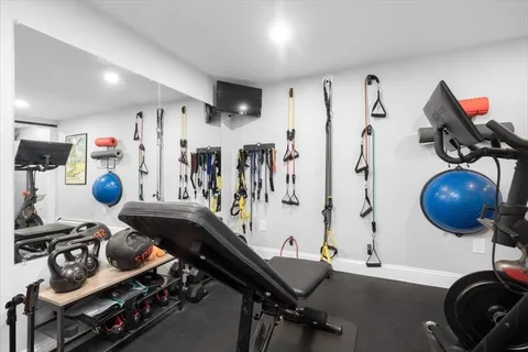 a gym room with lots of gym equipment