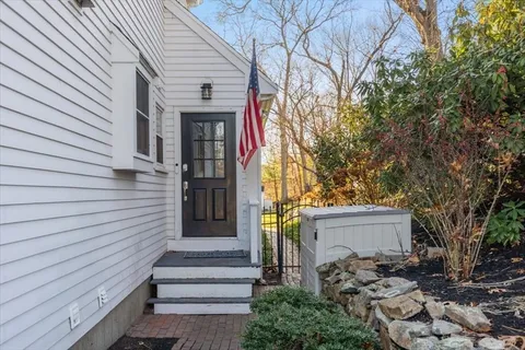 a front view of a house with a tree