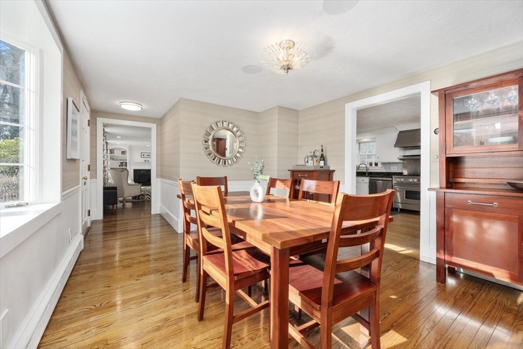 38 Smith Road Hingham, MA 02043 - Photo 8 of 42 a dining room with furniture a kitchen a chandelier and wooden floor