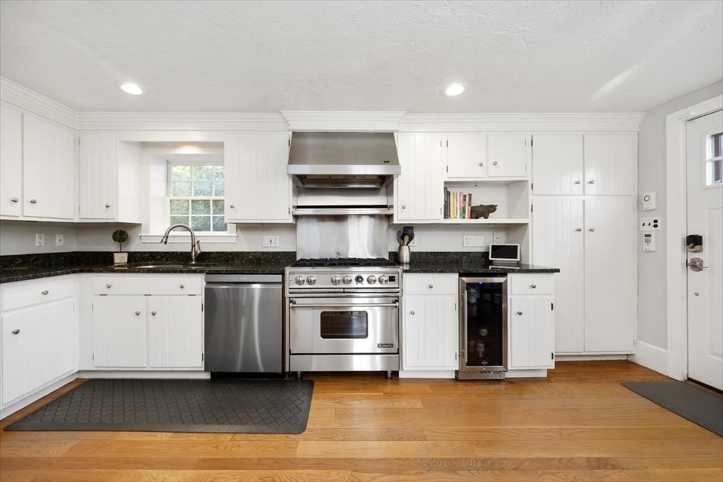 38 Smith Road Hingham, MA 02043 - Photo 9 of 42 a kitchen with stainless steel appliances granite countertop a stove a sink and white cabinets