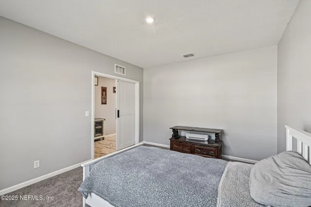 a bedroom with a bed and cabinets