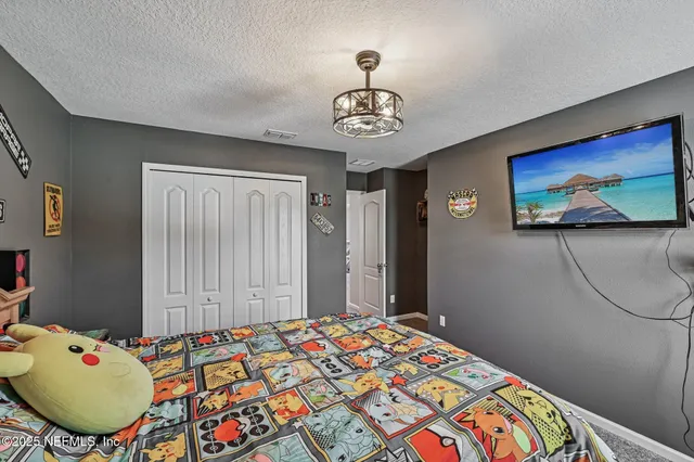 a bedroom with a bed dresser and a window