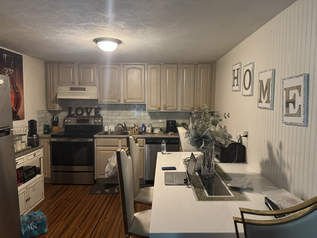 9 Walker Road, Unit 8 North Andover, MA 01845 - Photo 2 of 5 a kitchen with a sink and cabinets