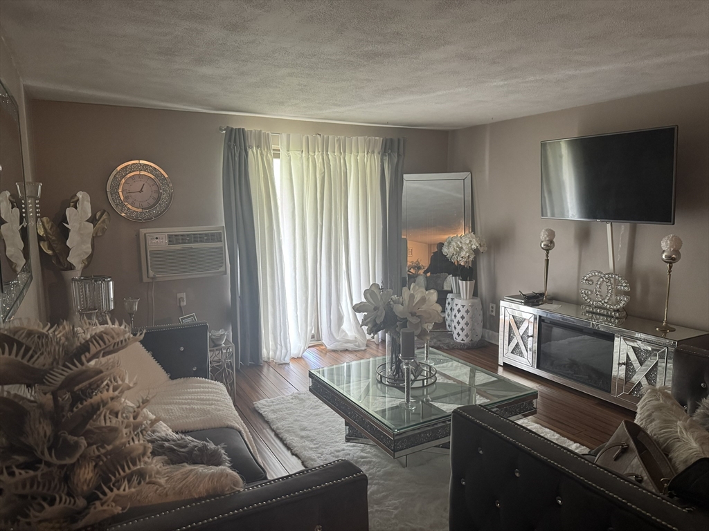 9 Walker Road, Unit 8 North Andover, MA 01845 - Photo 3 of 5 a living room with furniture and a flat screen tv
