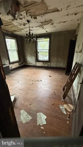 a view of a hallway with wooden walls and windows