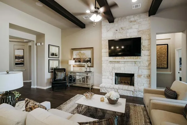a living room with furniture a fireplace and a flat screen tv