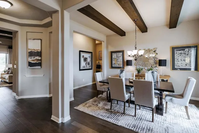 a dining room with furniture a chandelier and wooden floor