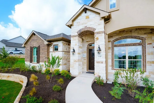 a front view of a house with garden