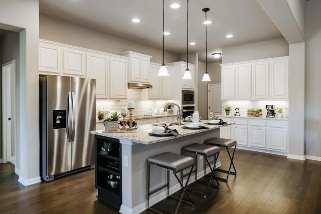 a kitchen with kitchen island appliances and wooden cabinets
