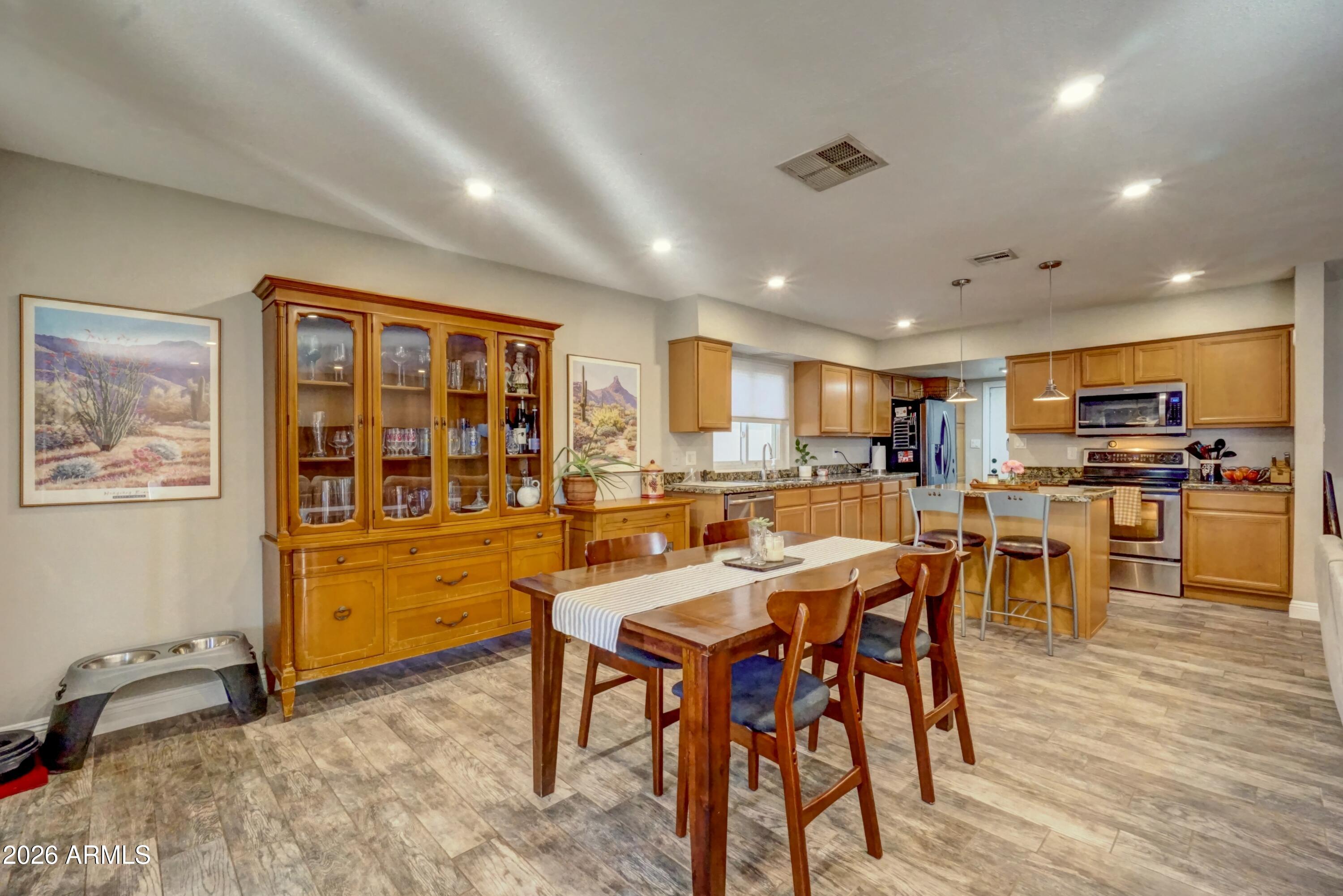 2749 East Sylvia Street Phoenix, AZ 85032 - Photo 11 of 44 a view of a dining room with furniture